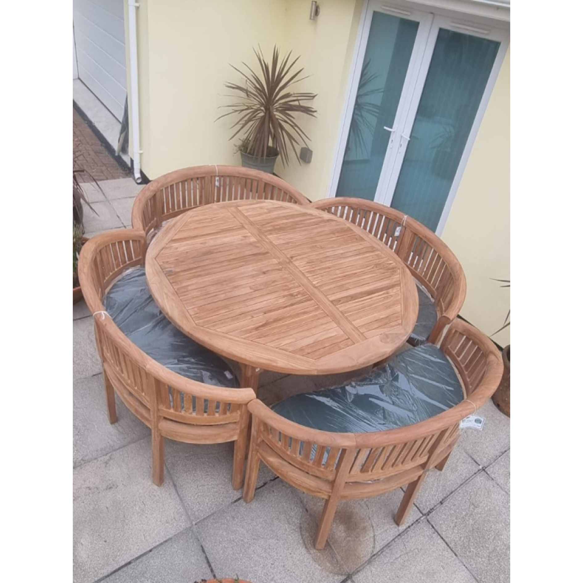 Teak garden dining set. 1.8m &ldquo;Titan&rdquo; round table, 4 bowwood style seats