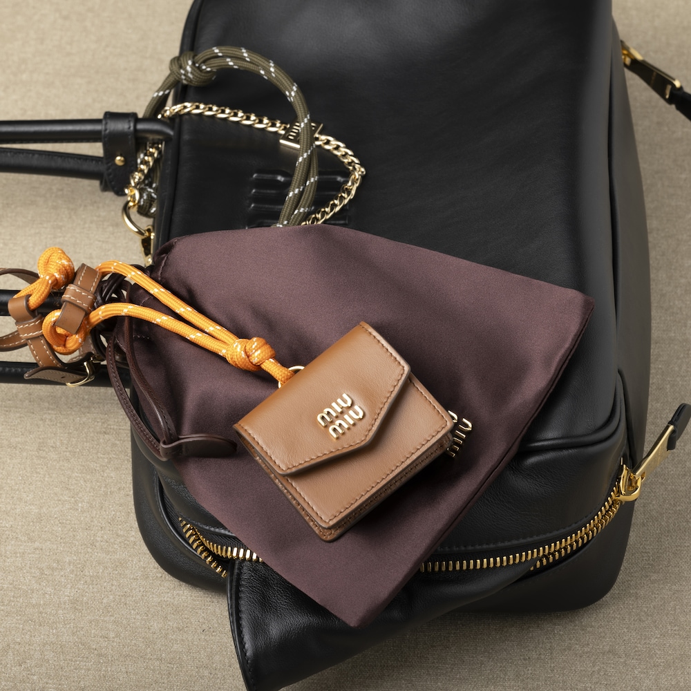 Leather, cord, and metal trick with mini-pouch