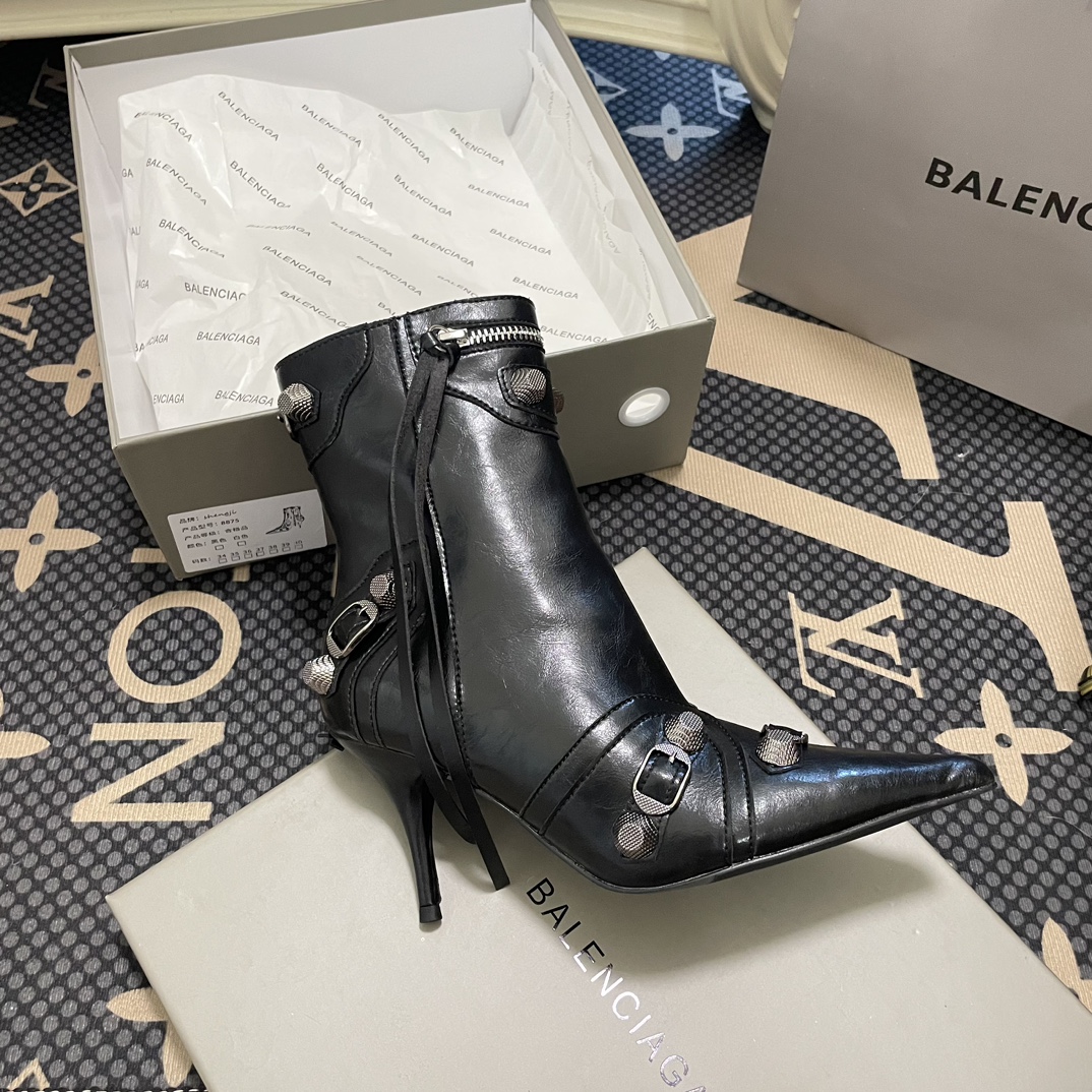 B  Metal-tipped pointed stiletto boots.