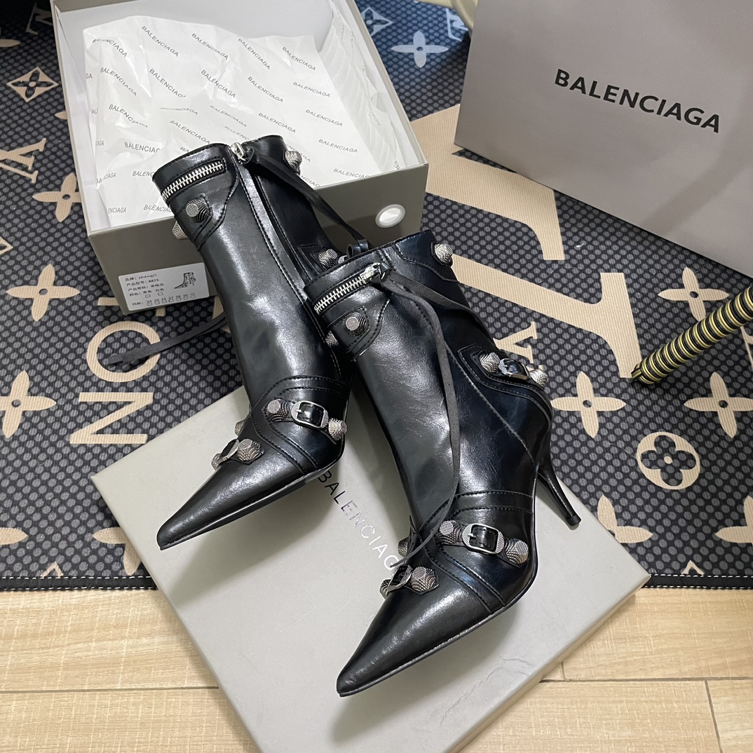 B  Metal-tipped pointed stiletto boots.