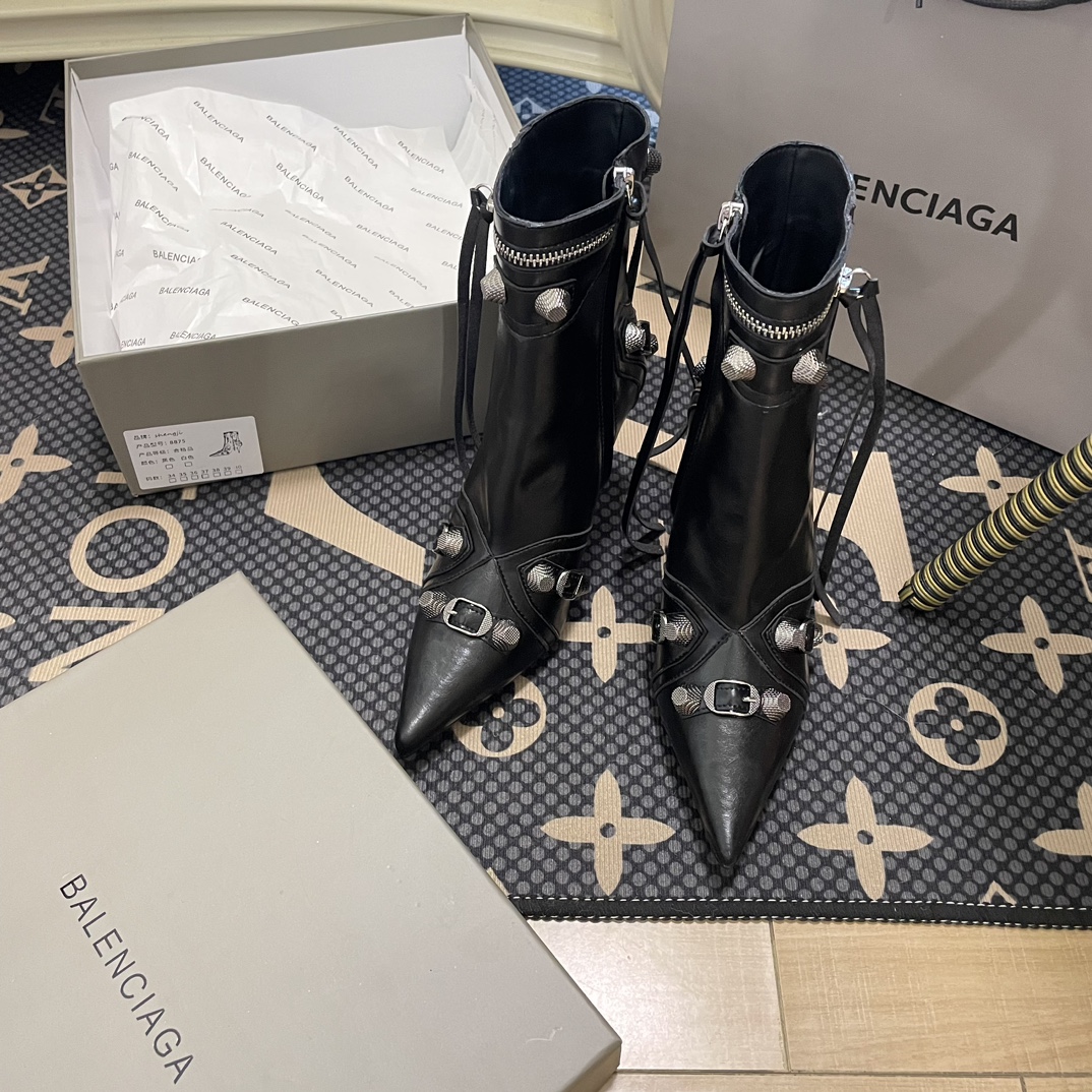 B  Metal-tipped pointed stiletto boots.