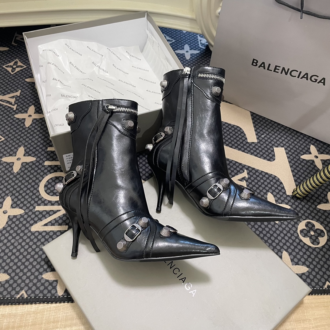 B  Metal-tipped pointed stiletto boots.