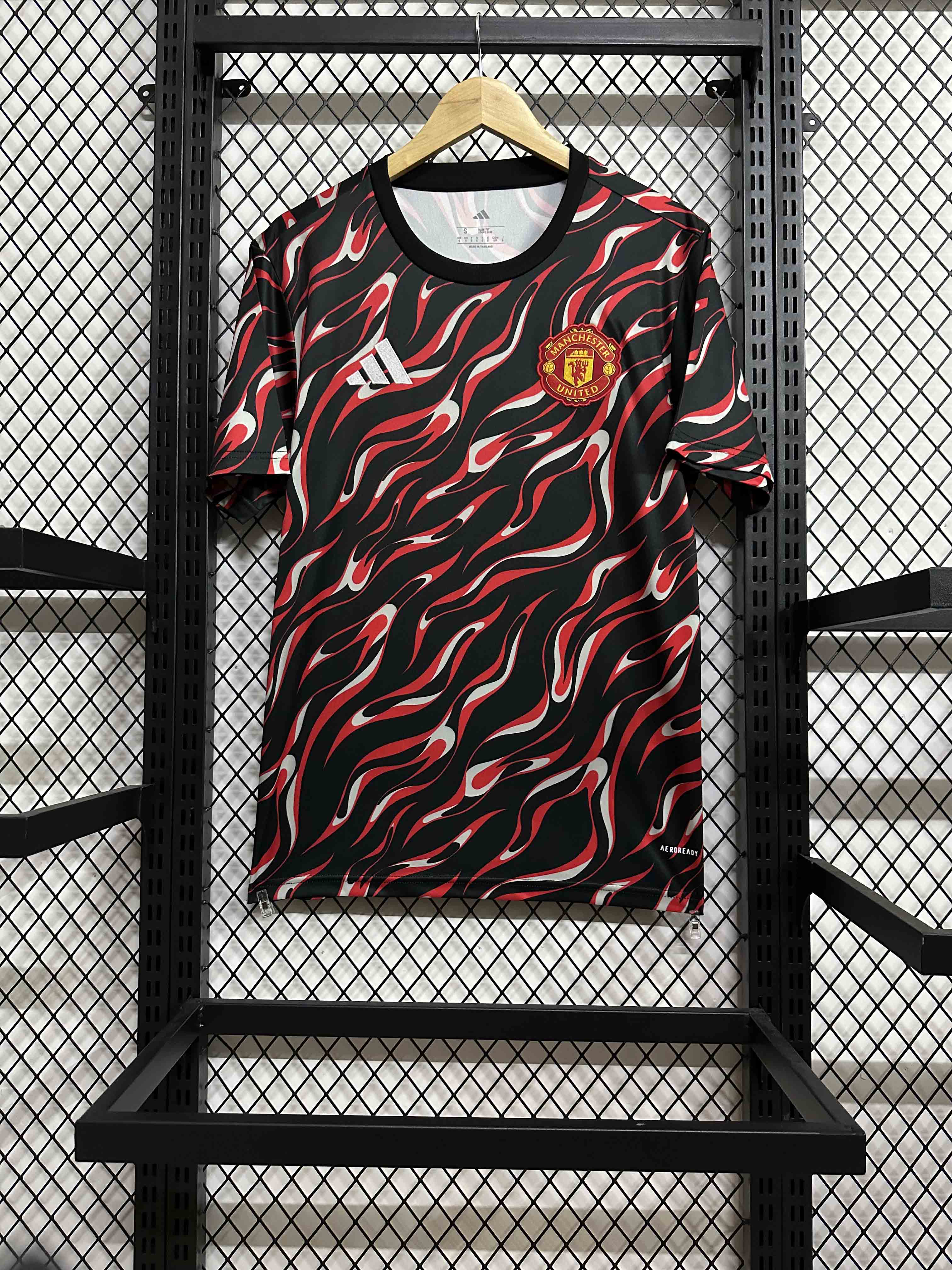 25-26 Manchester United's red and black training uniforms