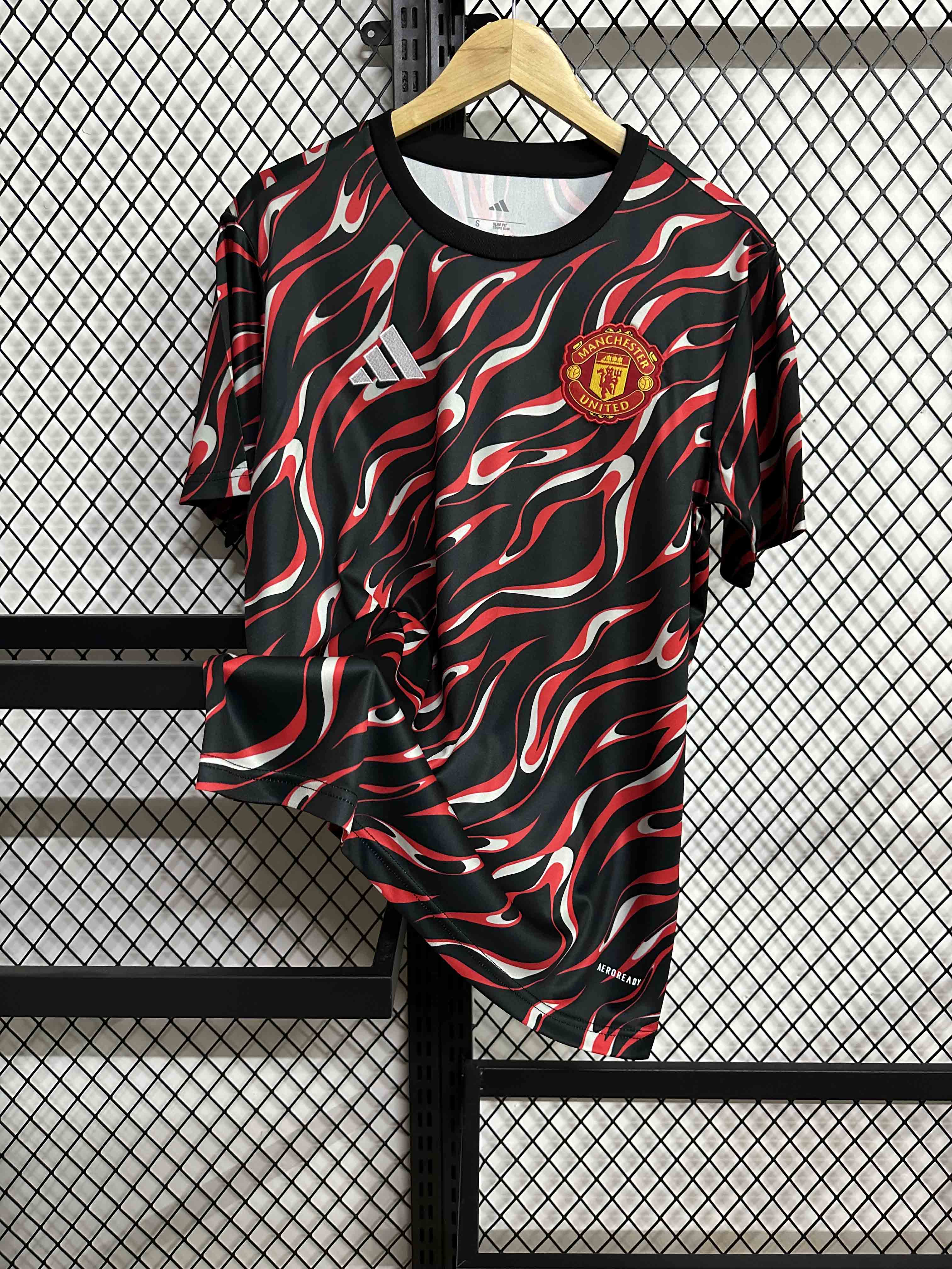 25-26 Manchester United's red and black training uniforms