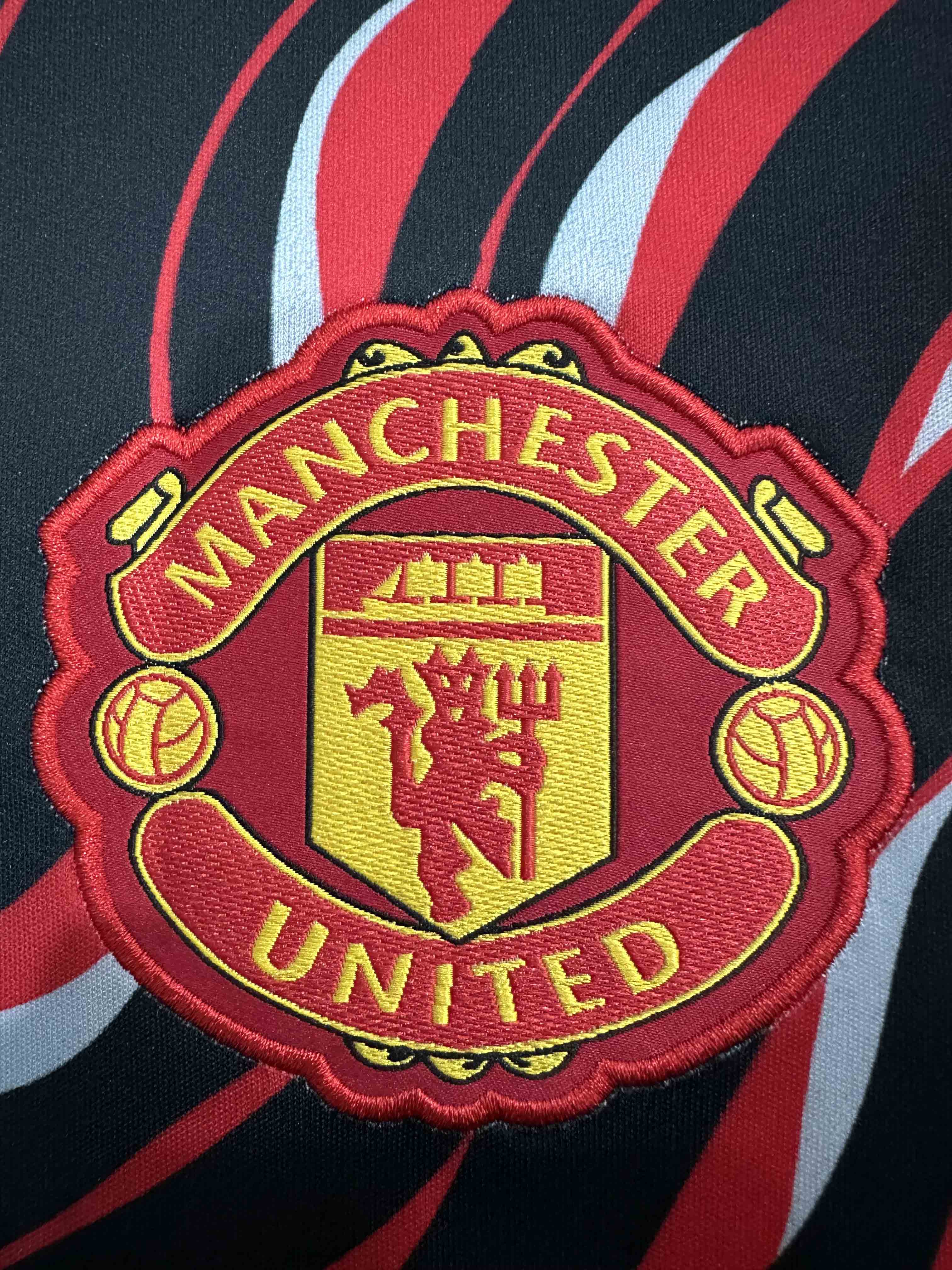 25-26 Manchester United's red and black training uniforms
