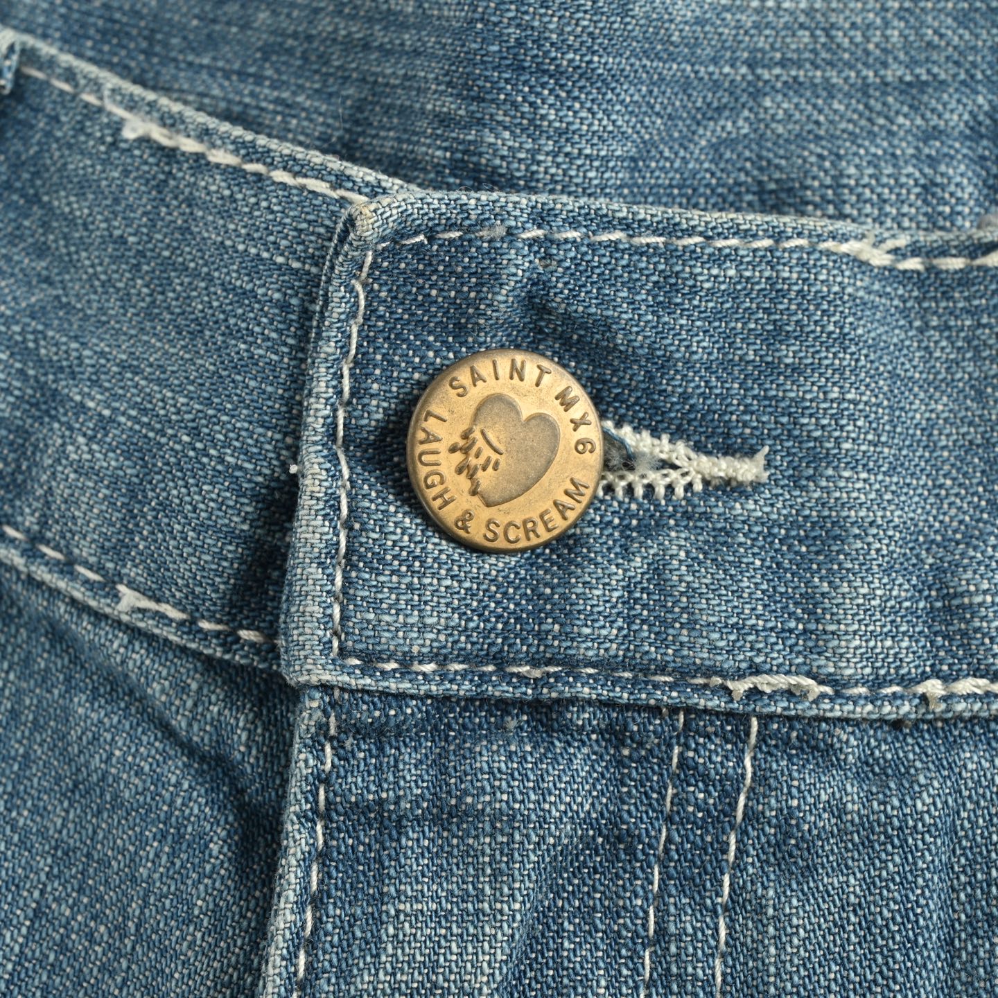 Ink-splattered raw-edge lumberjack denim shorts