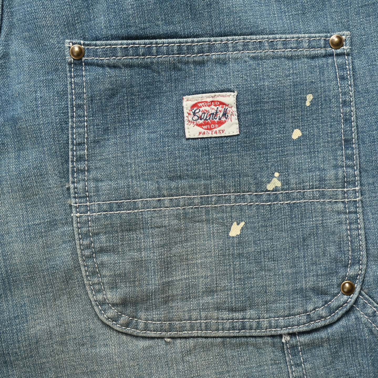 Ink-splattered raw-edge lumberjack denim shorts