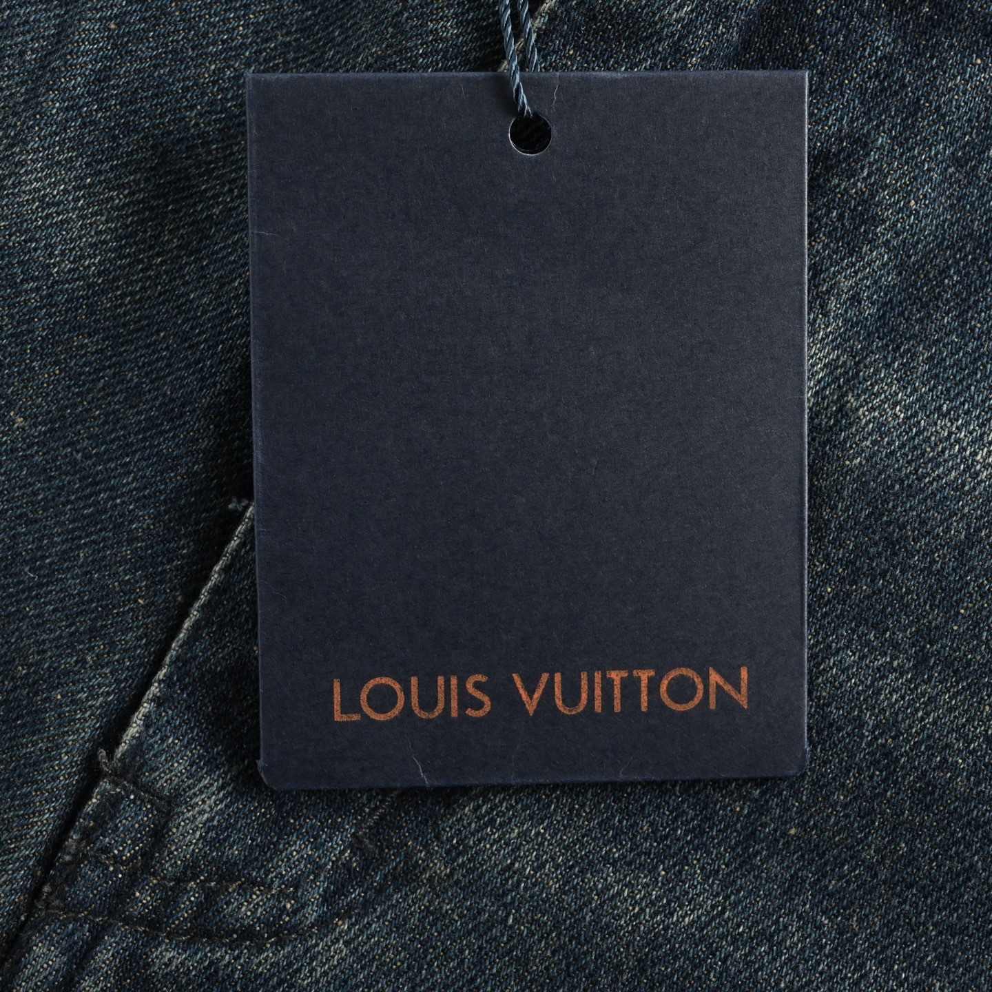 Denim shorts with embossed monogram pattern