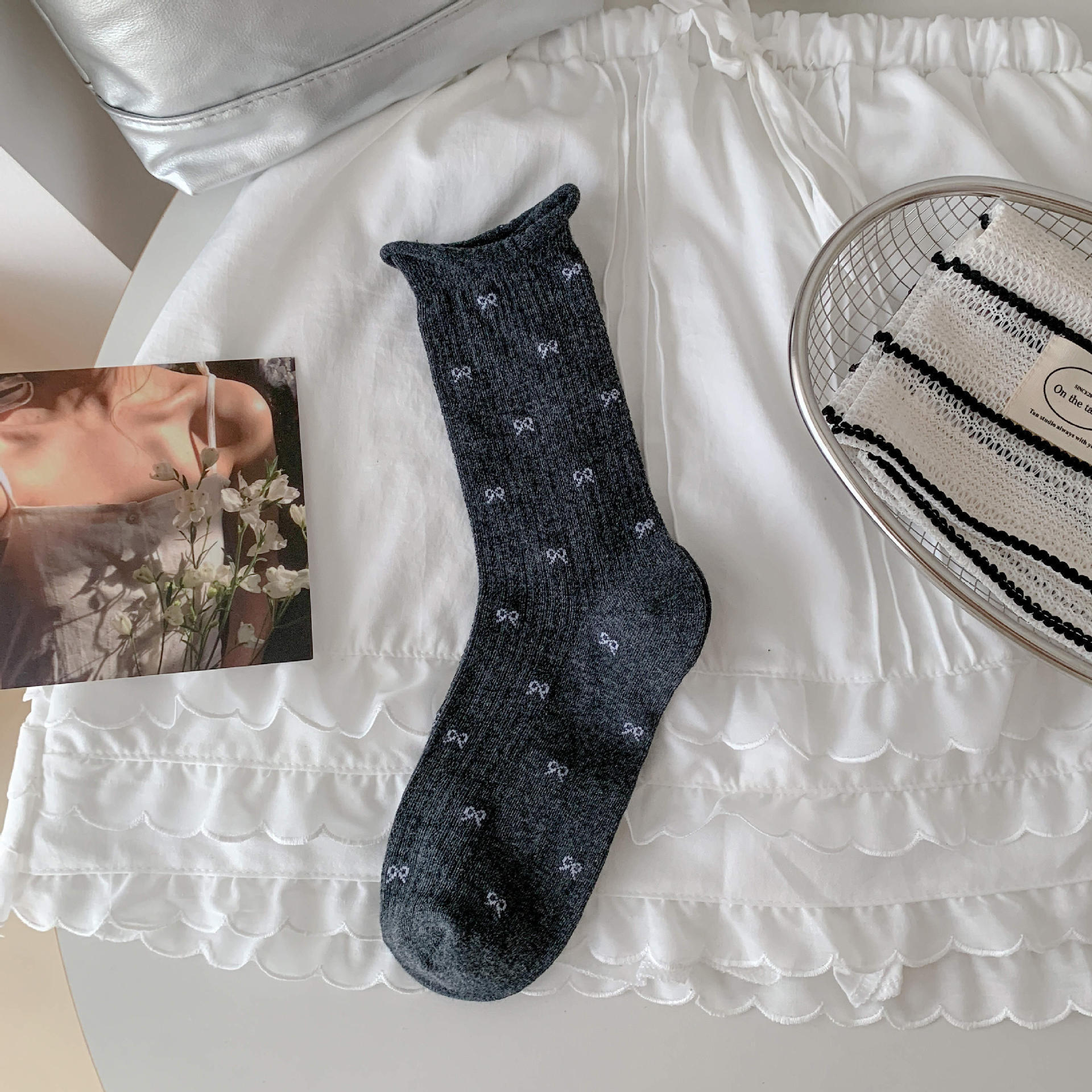 Bow socks paired with small leather shoes and rolled edge women's socks