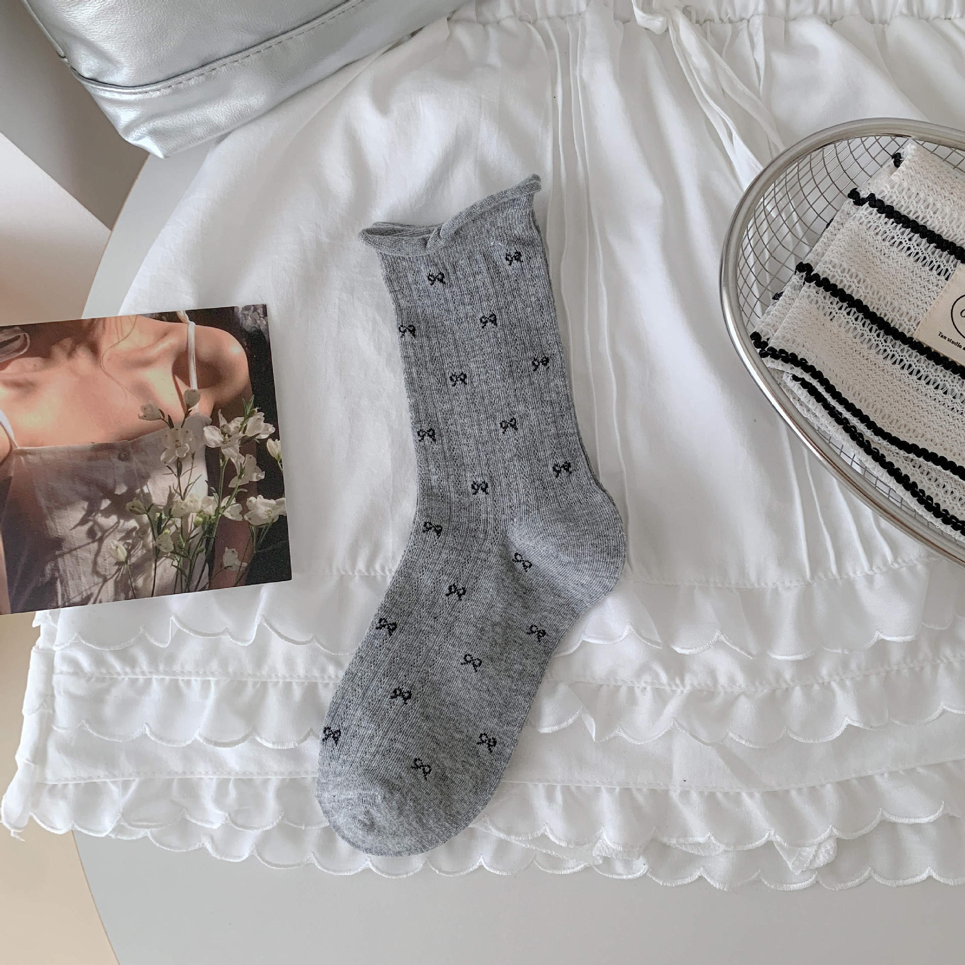 Bow socks paired with small leather shoes and rolled edge women's socks