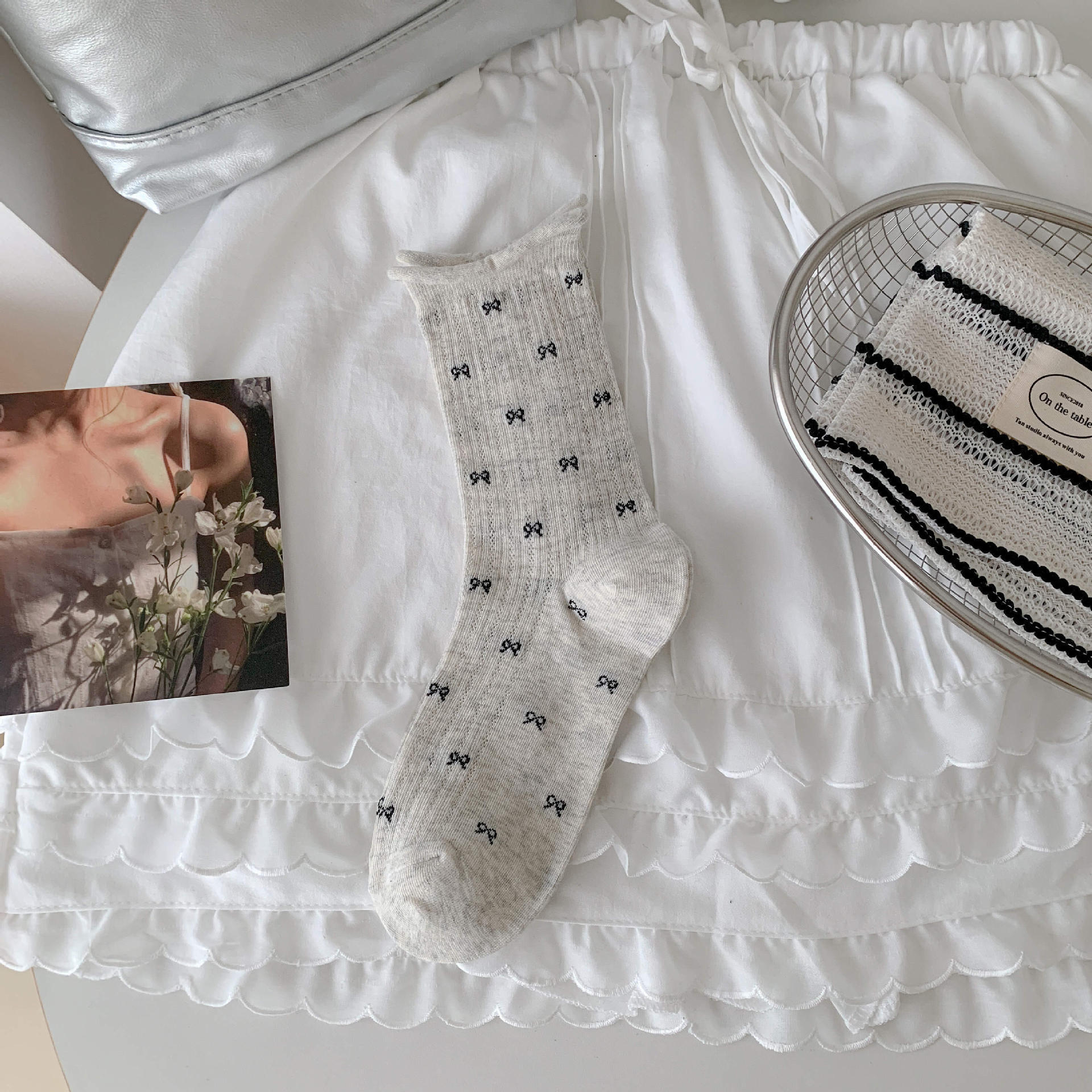 Bow socks paired with small leather shoes and rolled edge women's socks