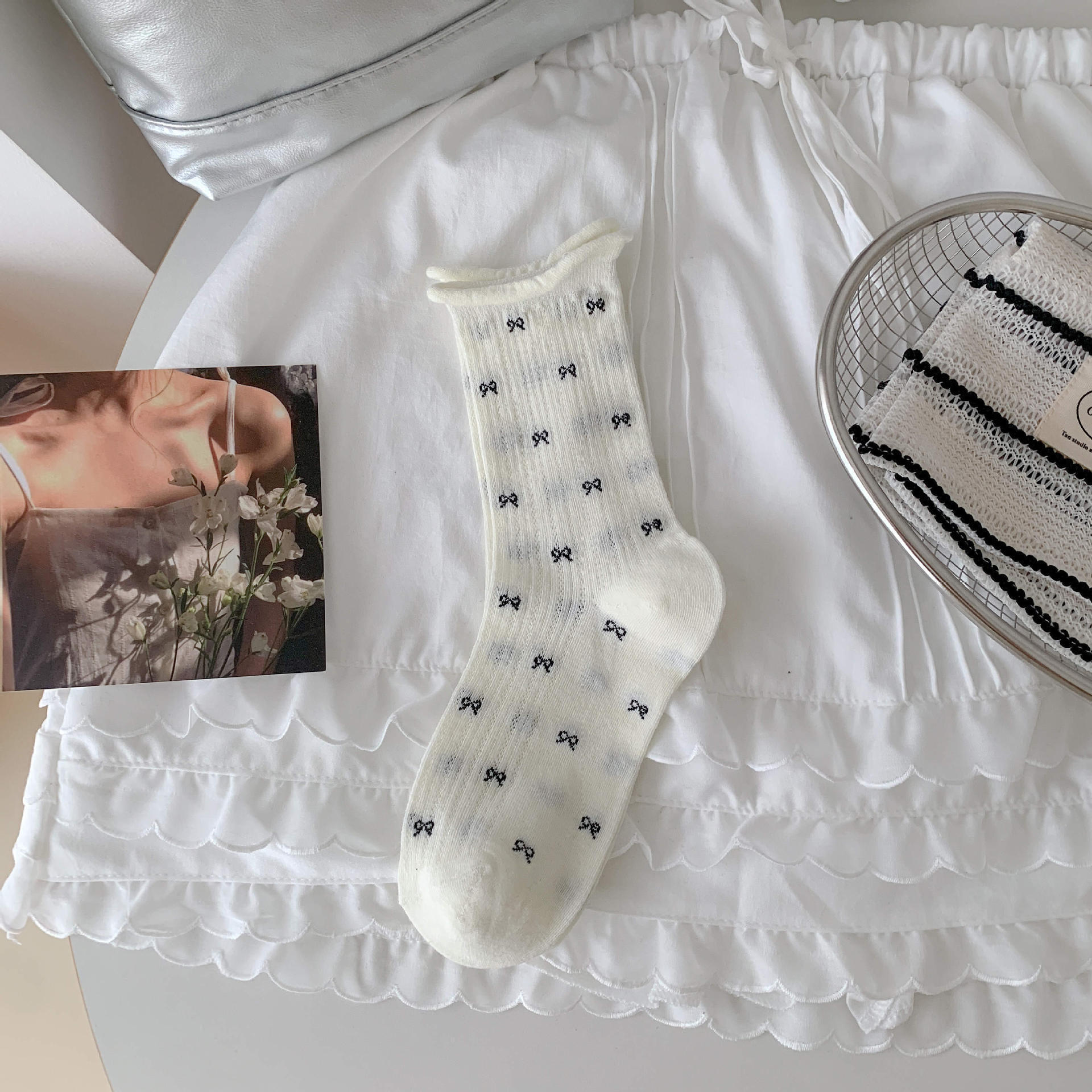 Bow socks paired with small leather shoes and rolled edge women's socks