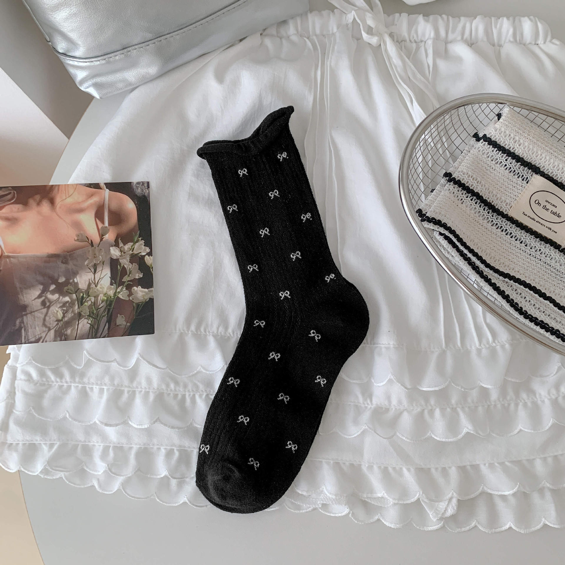 Bow socks paired with small leather shoes and rolled edge women's socks