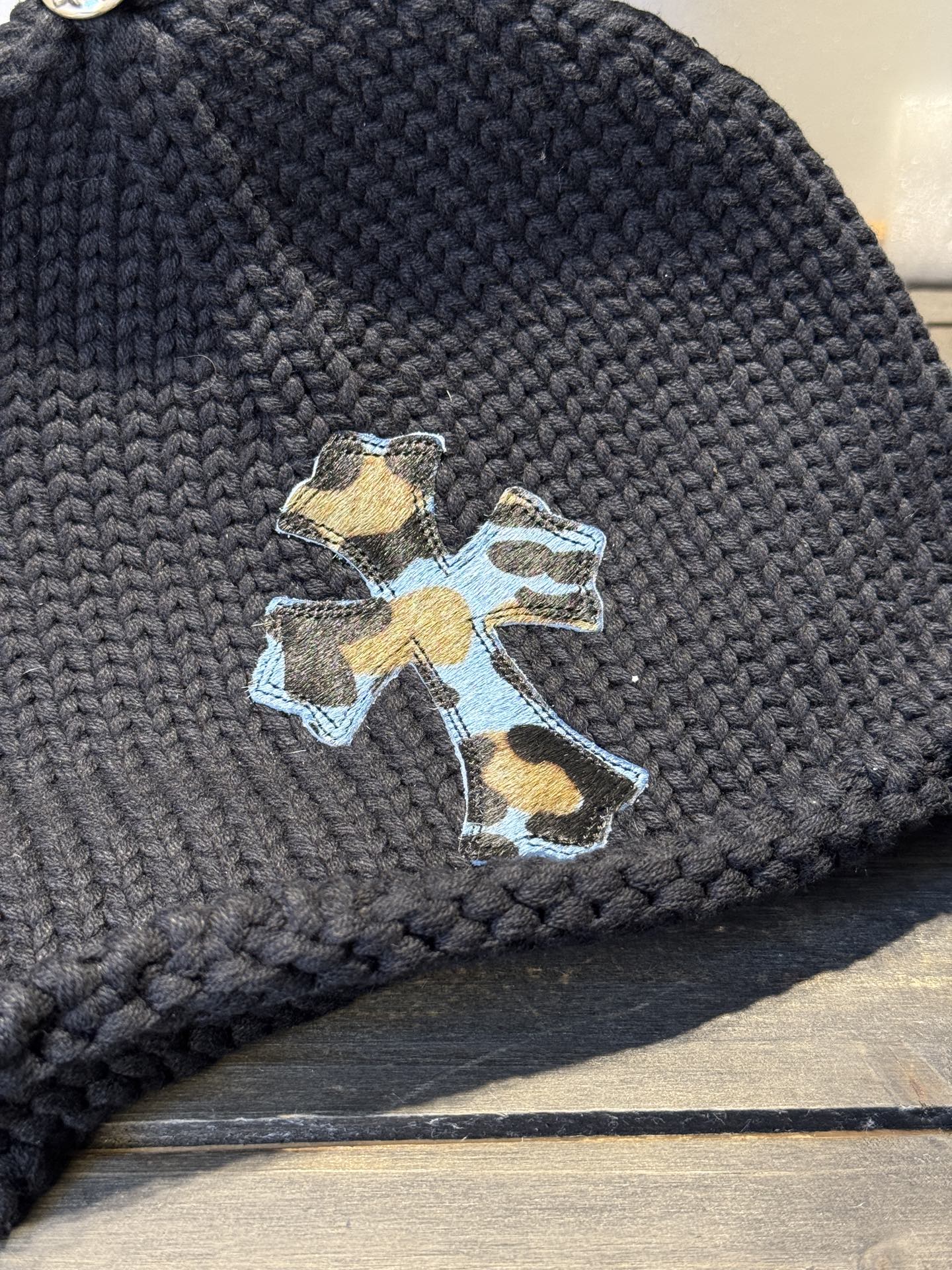 Custom-ordered leopard print cross beanie with sterling silver buckle and premium car emblem.