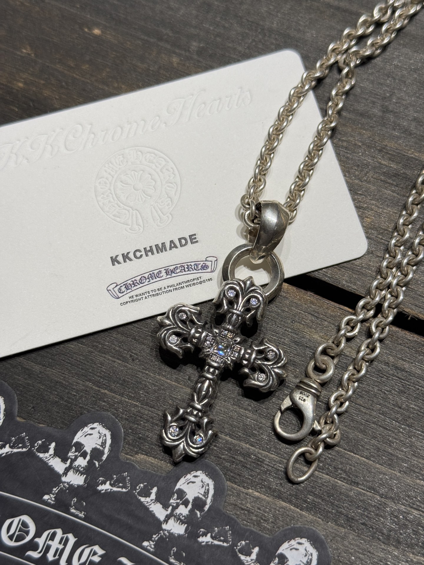 Custom-made for our client: Medium-sized flame cross necklace with full VVS diamond setting and lobster chain, featuring top-tier setting and engraving craftsmanship.