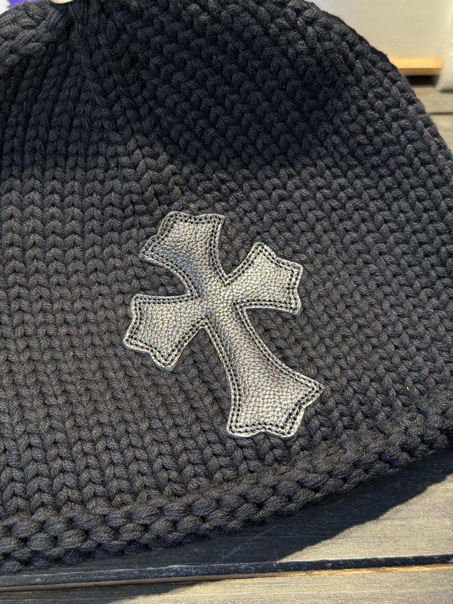 Custom-ordered cross-patterned leather beanie with sterling silver buckle and premium car emblem.