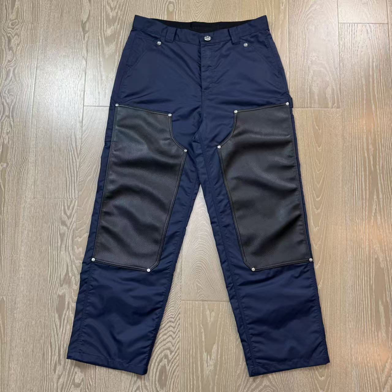 Chrome Hearts New Pants with Leather Patched and Logging FeaturesMatched design and color; silver-plated hardwareYellow leather cross on the backBoth knees are made from a single piece of leatherSizes 28, 30, 32, 34