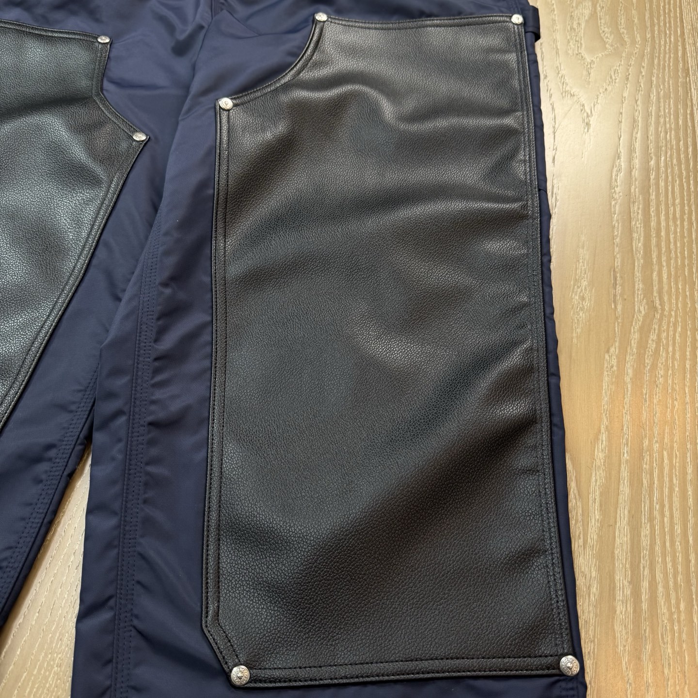 Chrome Hearts New Pants with Leather Patched and Logging FeaturesMatched design and color; silver-plated hardwareYellow leather cross on the backBoth knees are made from a single piece of leatherSizes 28, 30, 32, 34