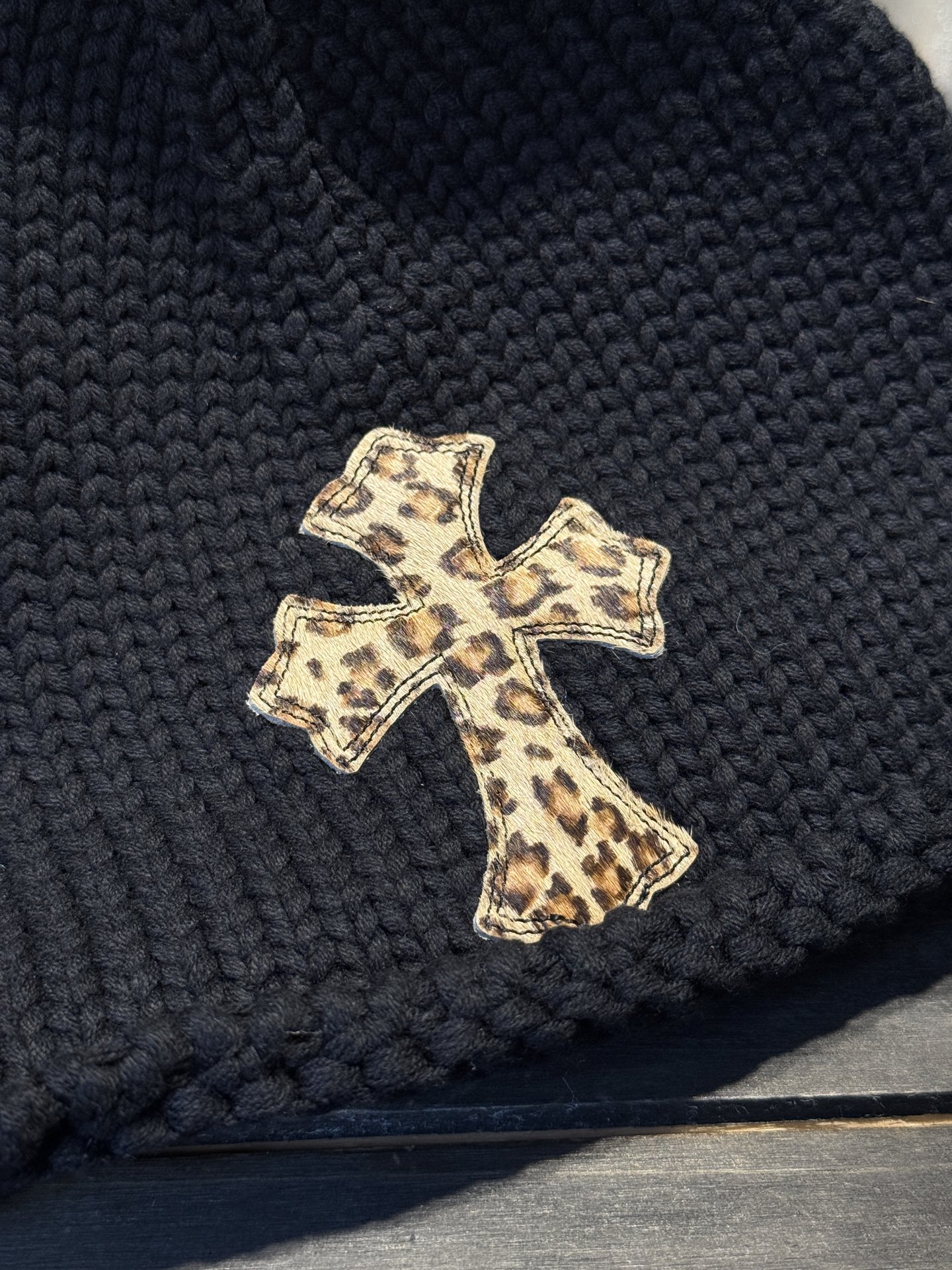 Custom-ordered leopard print cross beanie with sterling silver buckle and premium car emblem.