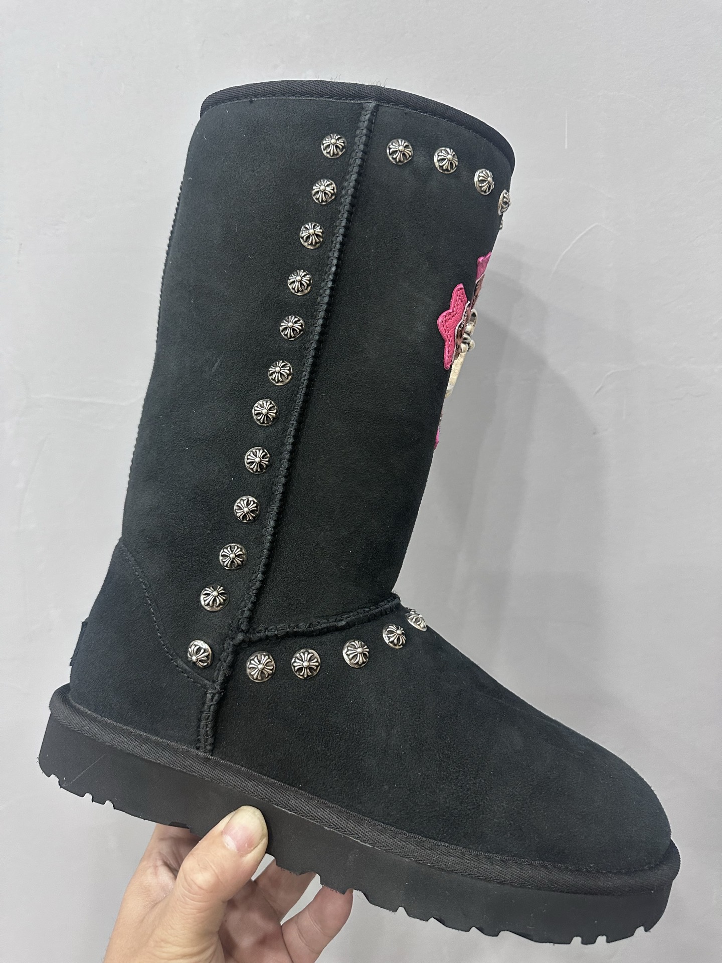 CH x UGG Classic black high-top suede and fur leather heavy-duty riveted snow boots.