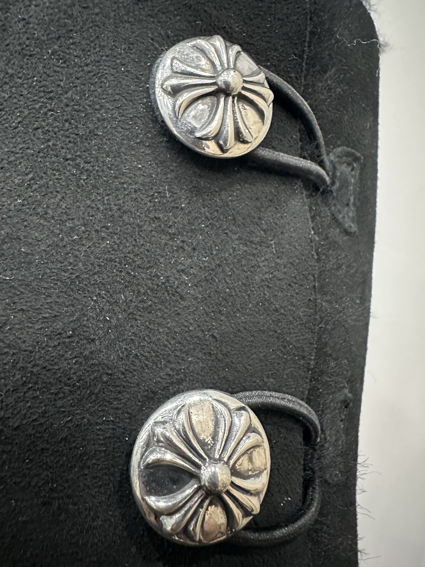 CH x UGG fur-coated black high-top side-button snow boots.