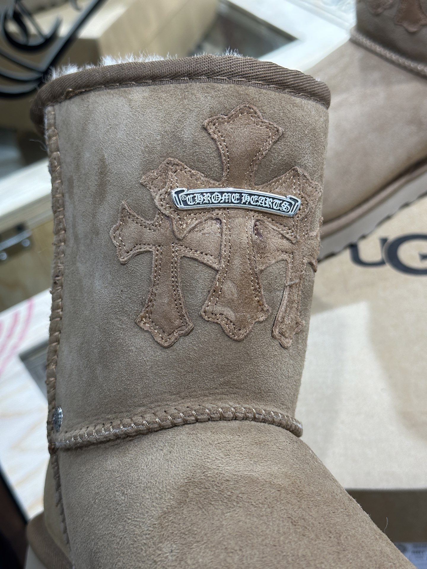 CH x UGG Cardigan-style fur-and-leather one-piece rolled-up mid-calf snow boots.