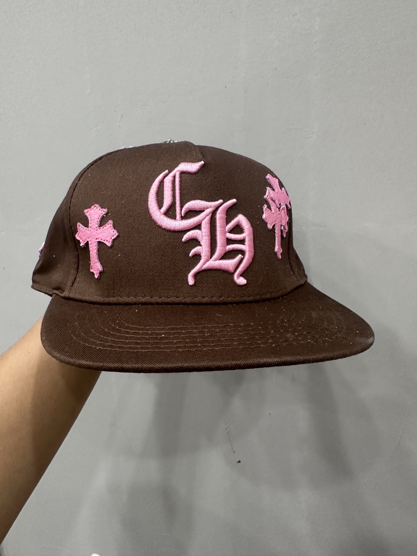 CH brown and pink striped baseball cap with a pink leather strap. Truck-style hat.