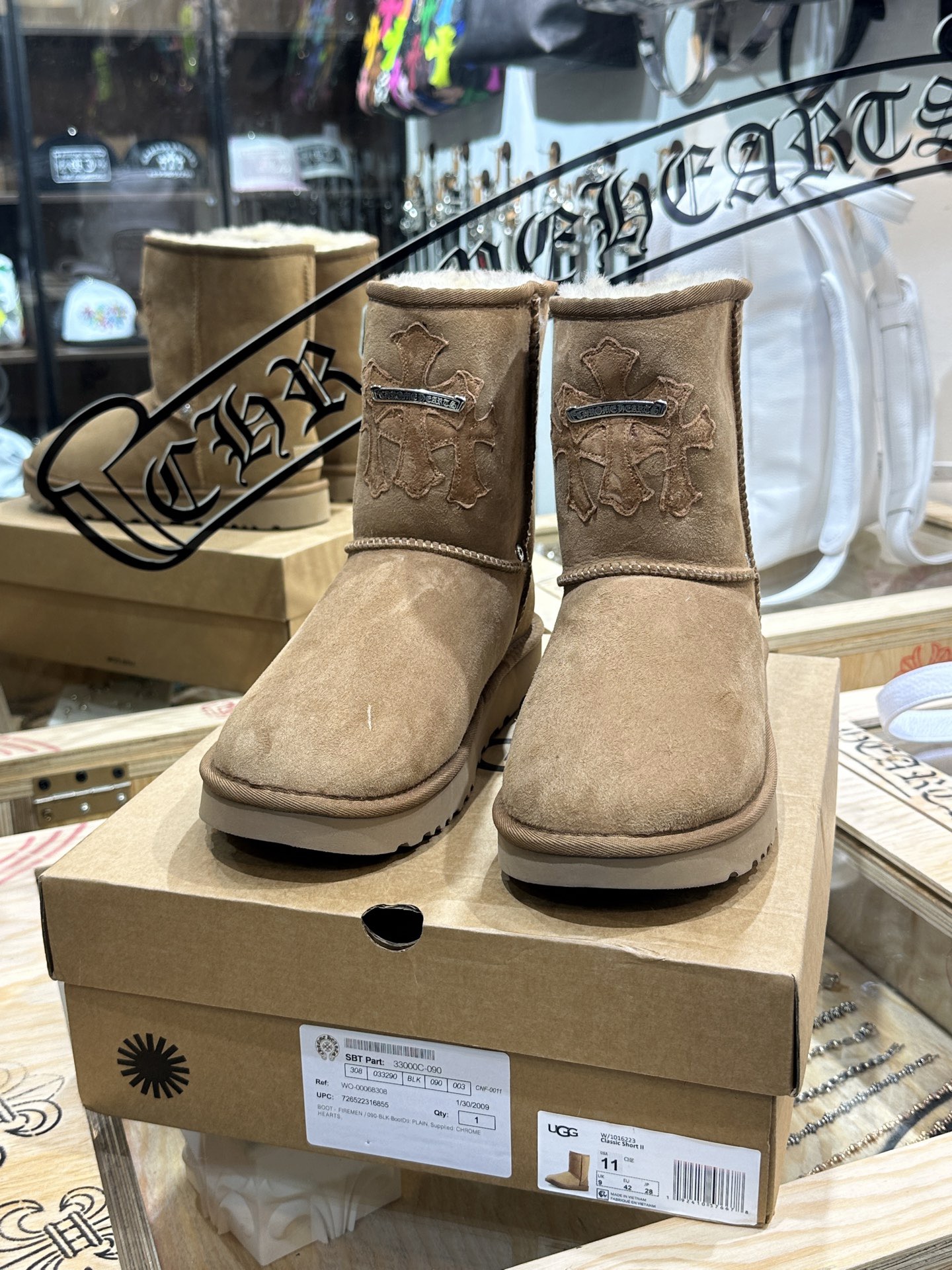 CH x UGG Cardigan-style fur-and-leather one-piece rolled-up mid-calf snow boots.