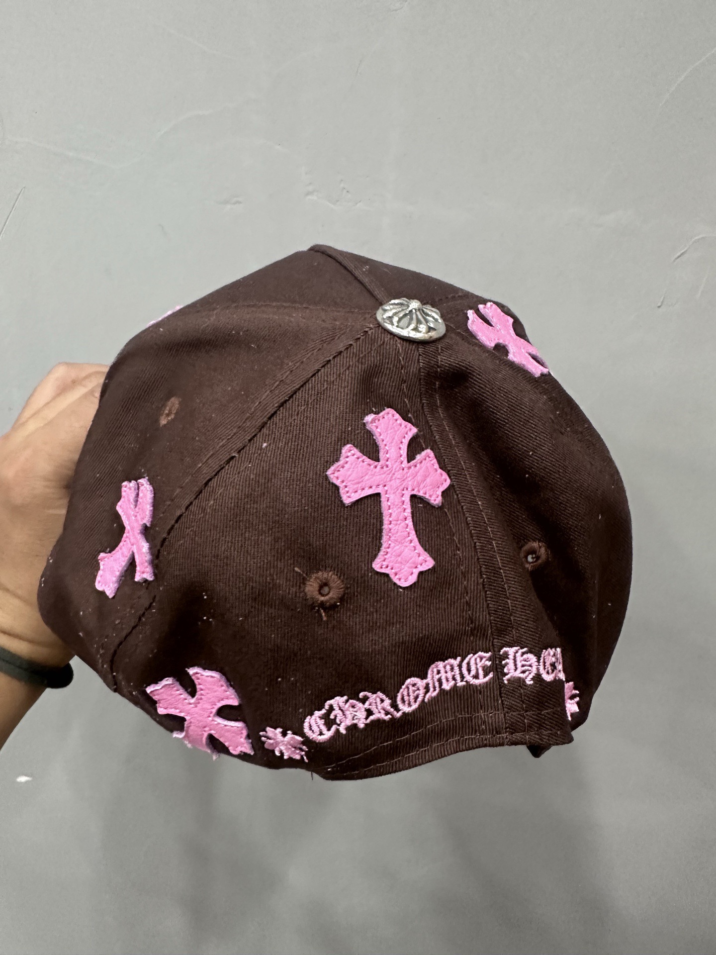 CH brown and pink striped baseball cap with a pink leather strap. Truck-style hat.