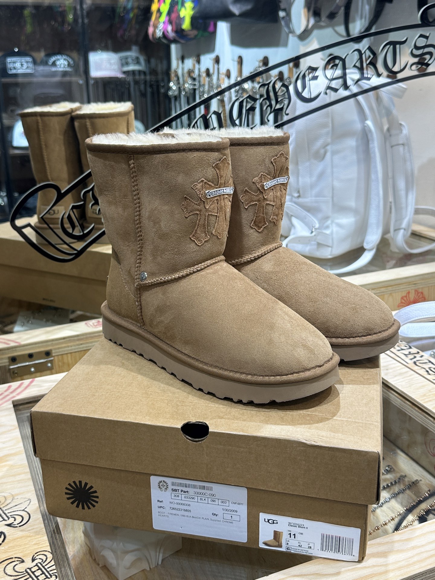 CH x UGG Cardigan-style fur-and-leather one-piece rolled-up mid-calf snow boots.