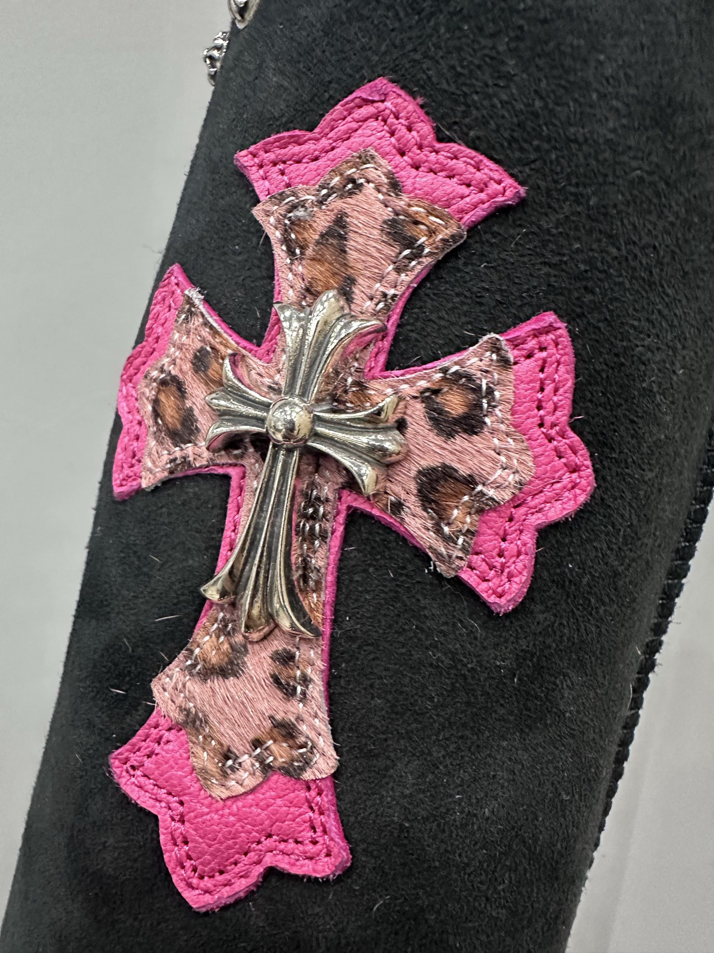 CH x UGG Classic black high-top suede and fur leather heavy-duty riveted snow boots.